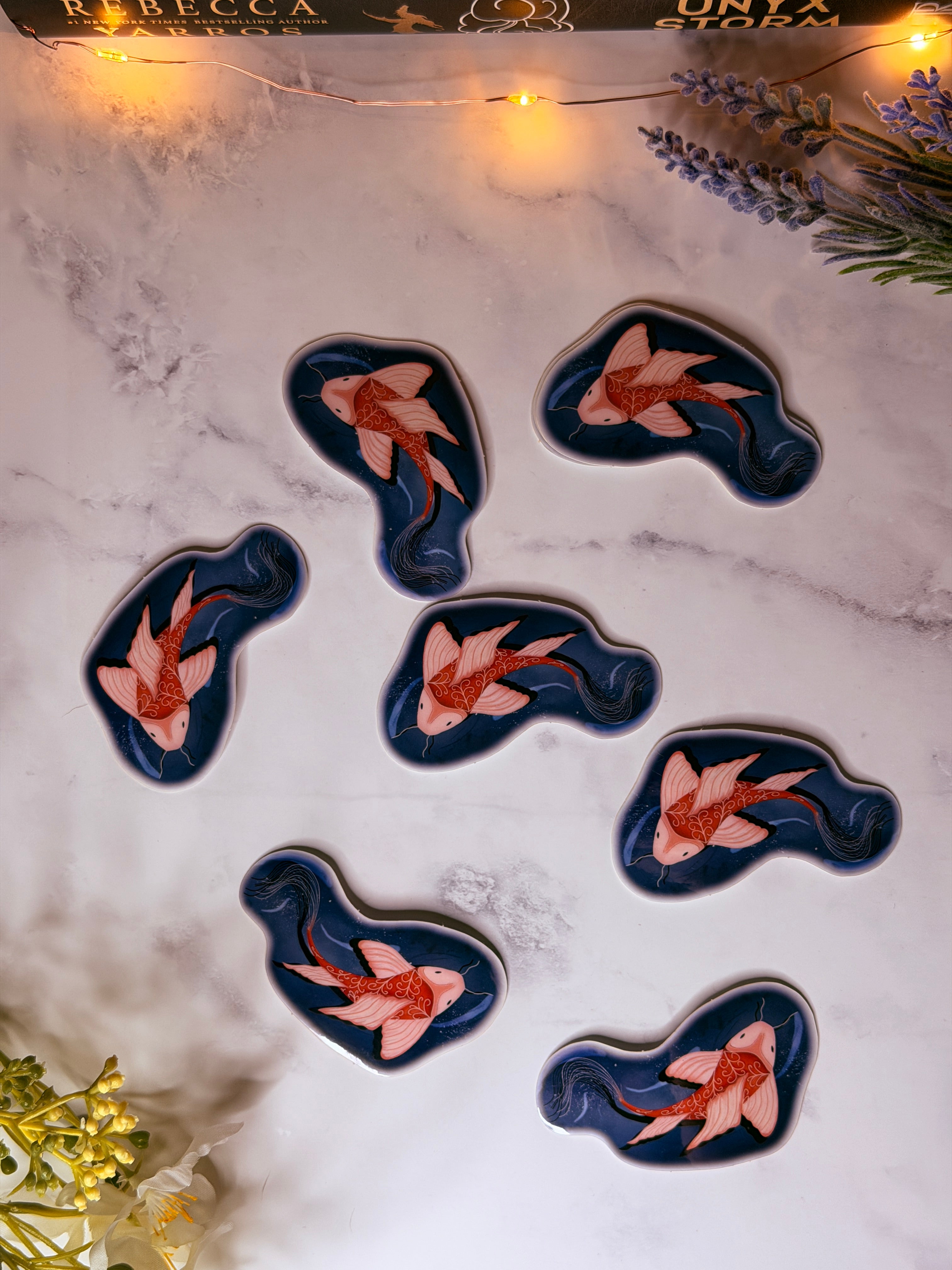 Decorative stickers with fish design on a marble surface